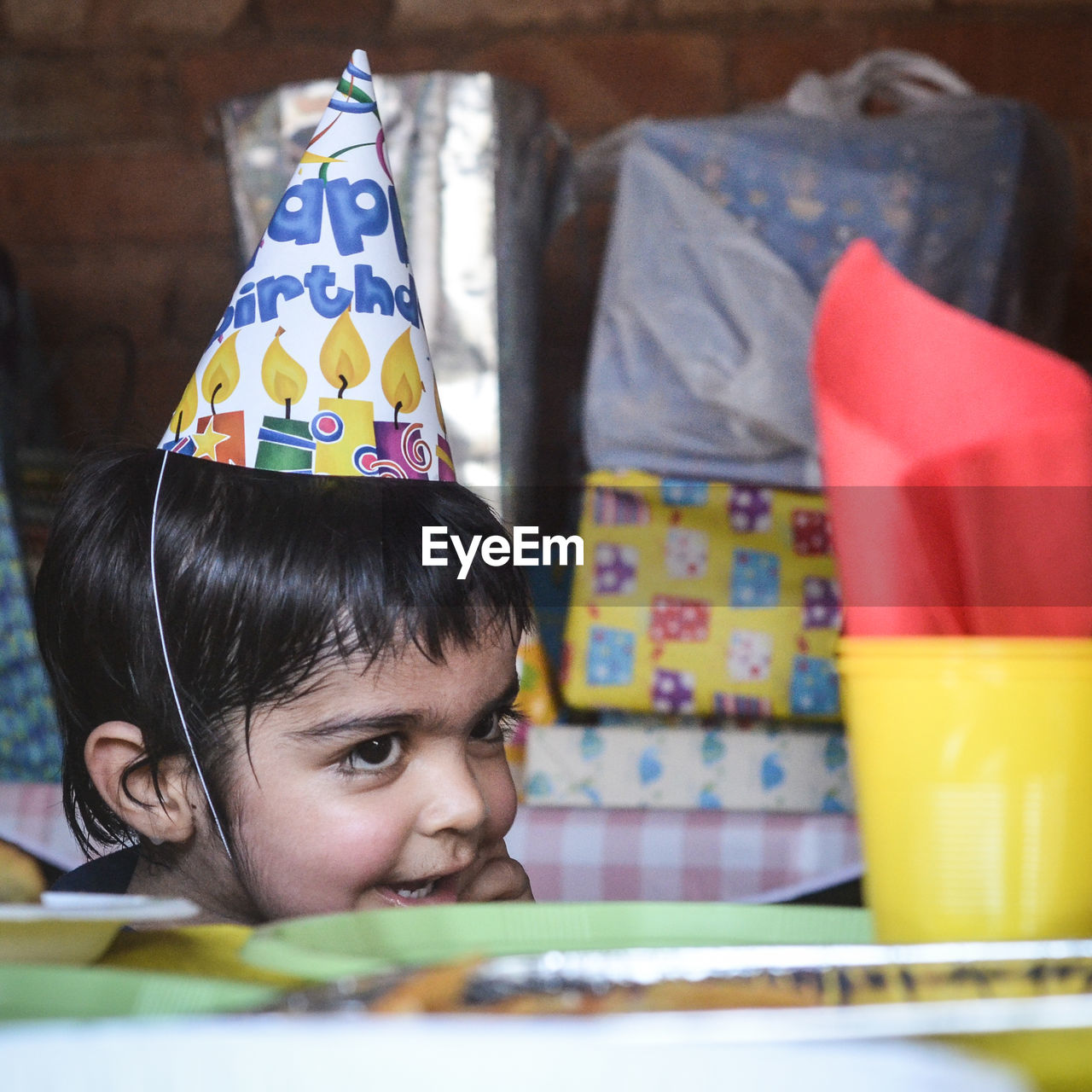 Close-up of boy wearing party hat at home