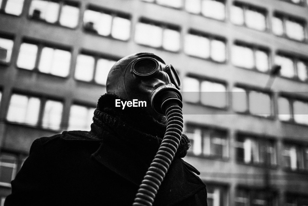 Low angle view of man wearing gas mask
