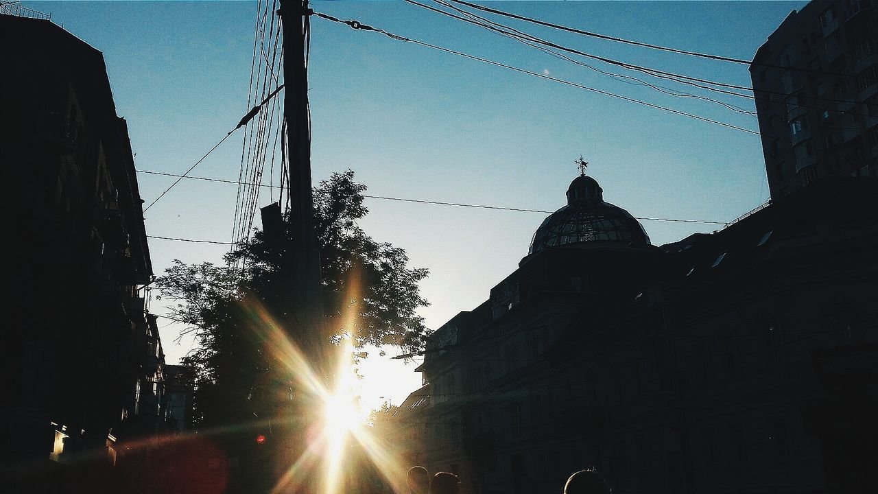 LOW ANGLE VIEW OF POWER LINES AGAINST SUNSET SKY