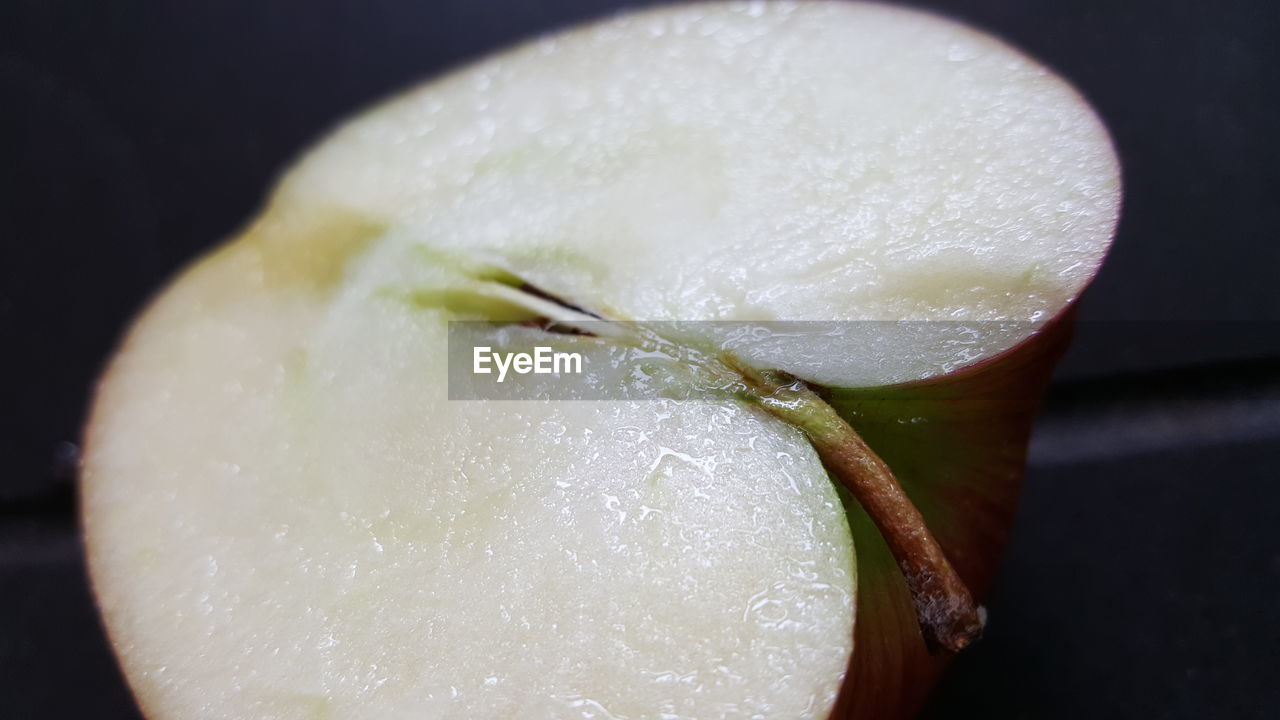 Close-up of halved apple on table