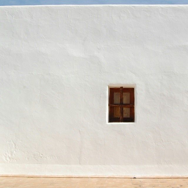 White wall with small closed window