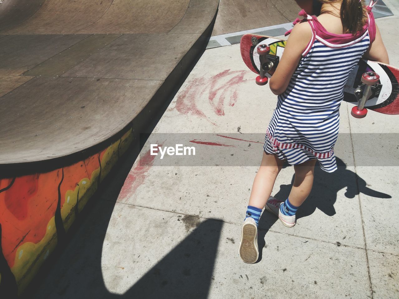 HIGH ANGLE VIEW OF BOY IN SHADOW ON FLOOR