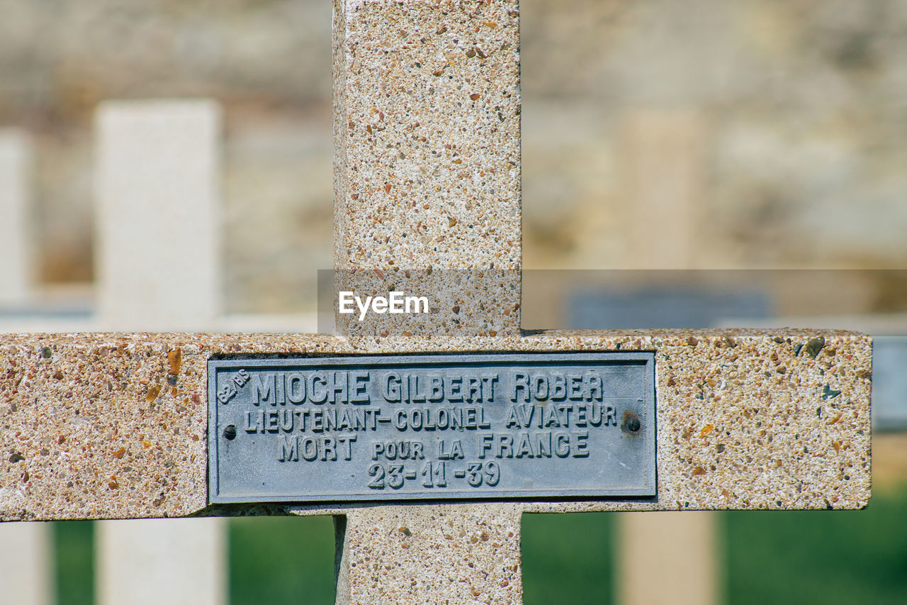 CLOSE-UP OF TEXT ON OLD RUSTY METAL