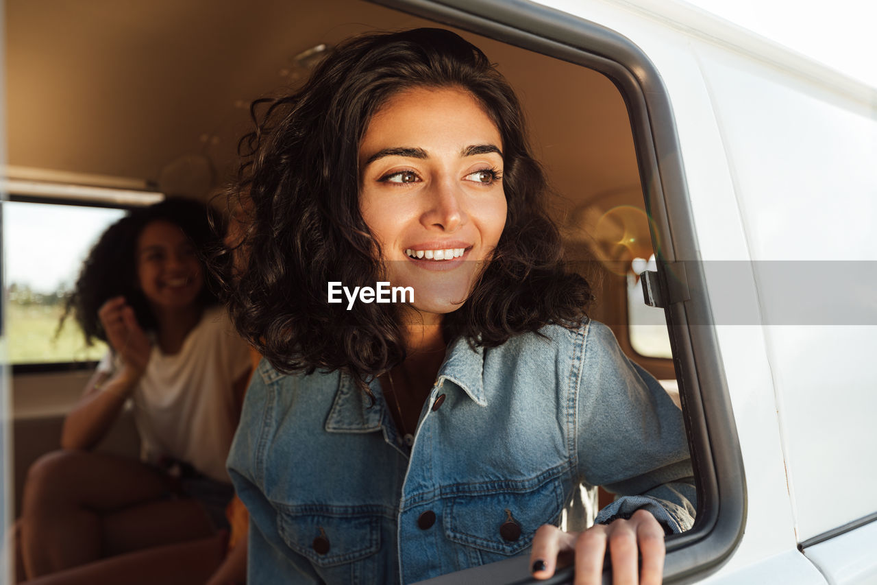 Portrait of smiling woman sitting in car