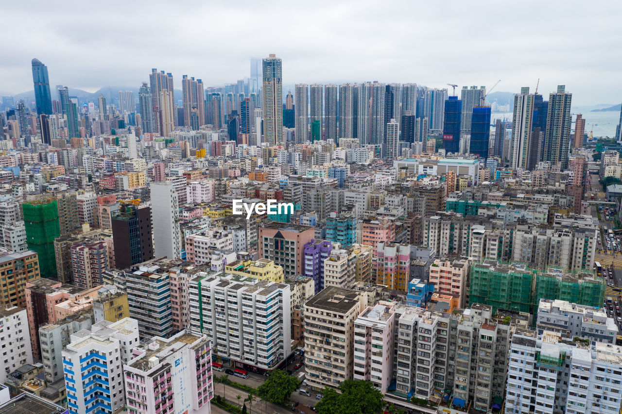 AERIAL VIEW OF MODERN CITYSCAPE AGAINST SKY