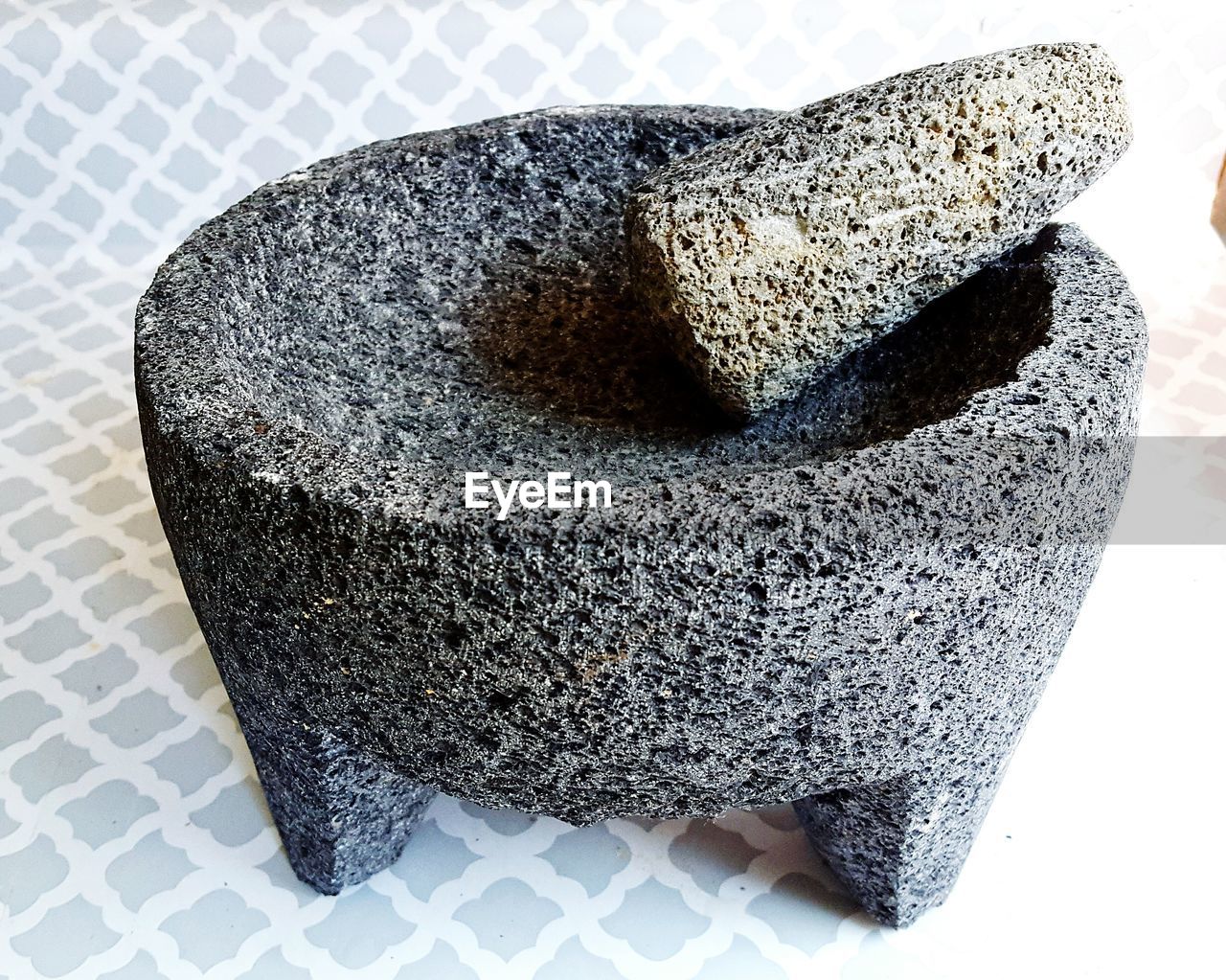 Close-up of stone mortar and pestle on floor