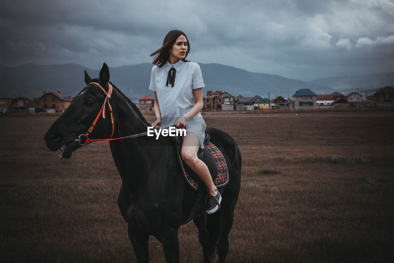 Woman on horse in field