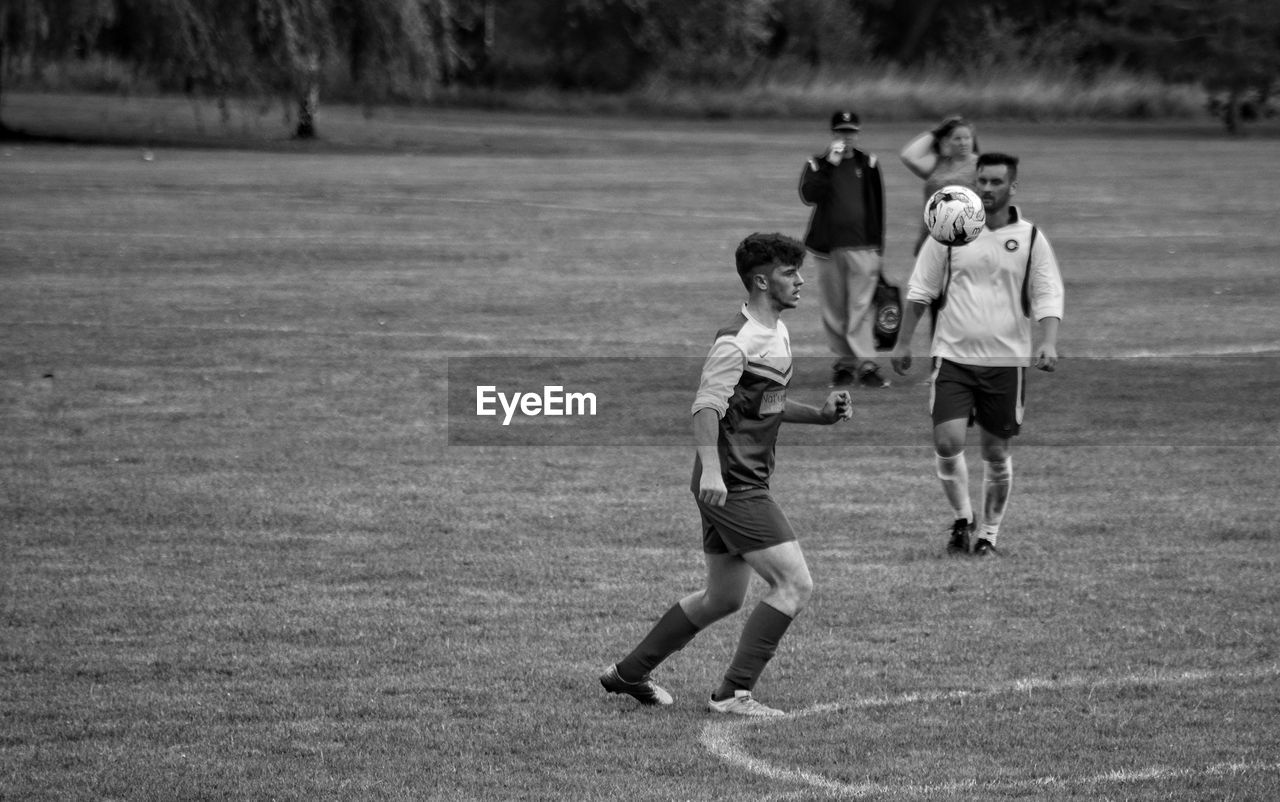 BOYS PLAYING SOCCER FIELD