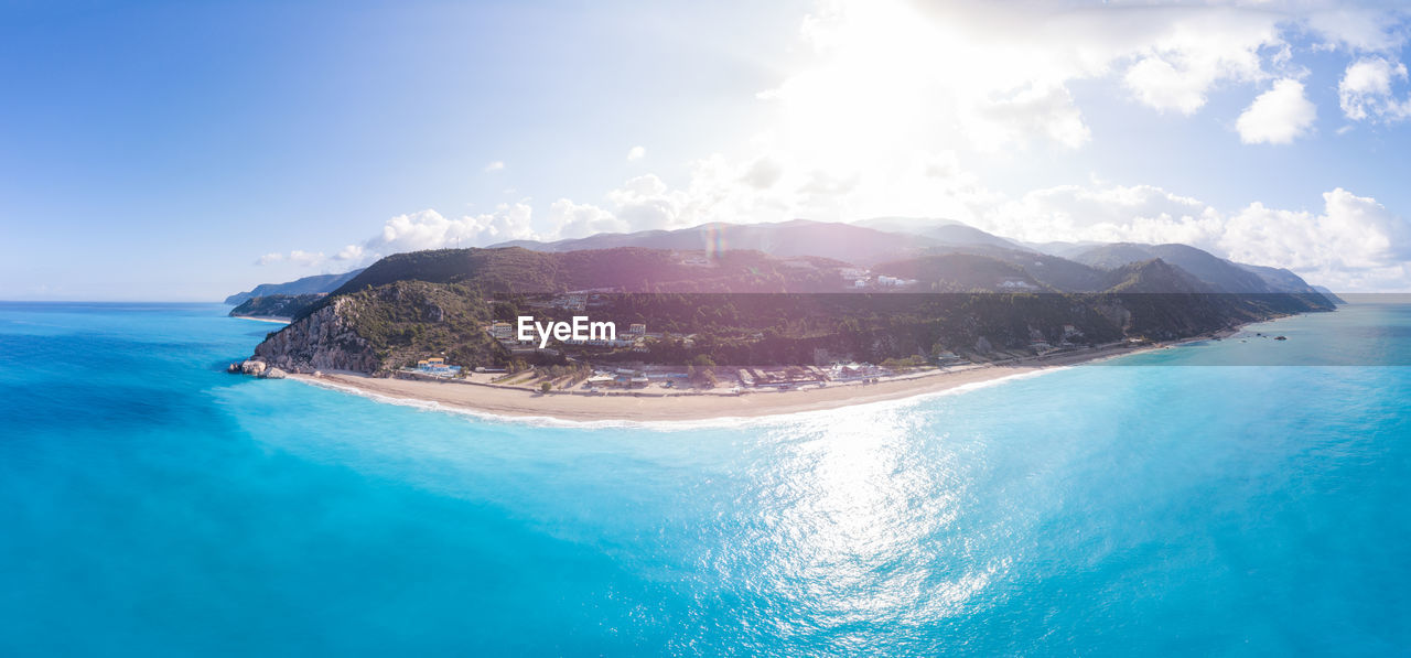 scenic view of sea and mountains against sky