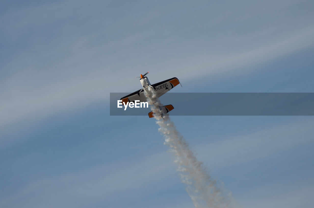 LOW ANGLE VIEW OF AIRPLANE AGAINST SKY