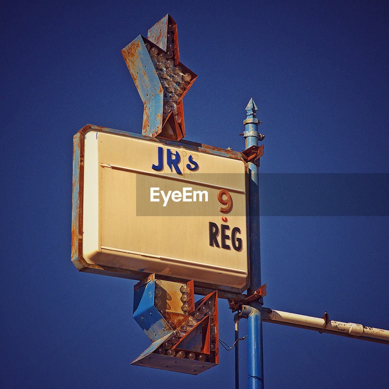 LOW ANGLE VIEW OF ROAD SIGNS AGAINST BLUE SKY