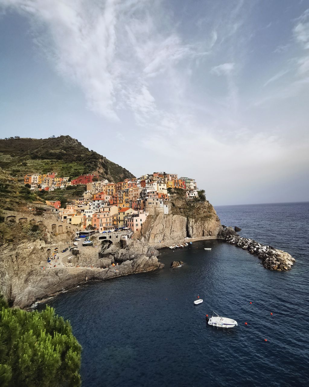 Scenic view of sea by buildings against sky