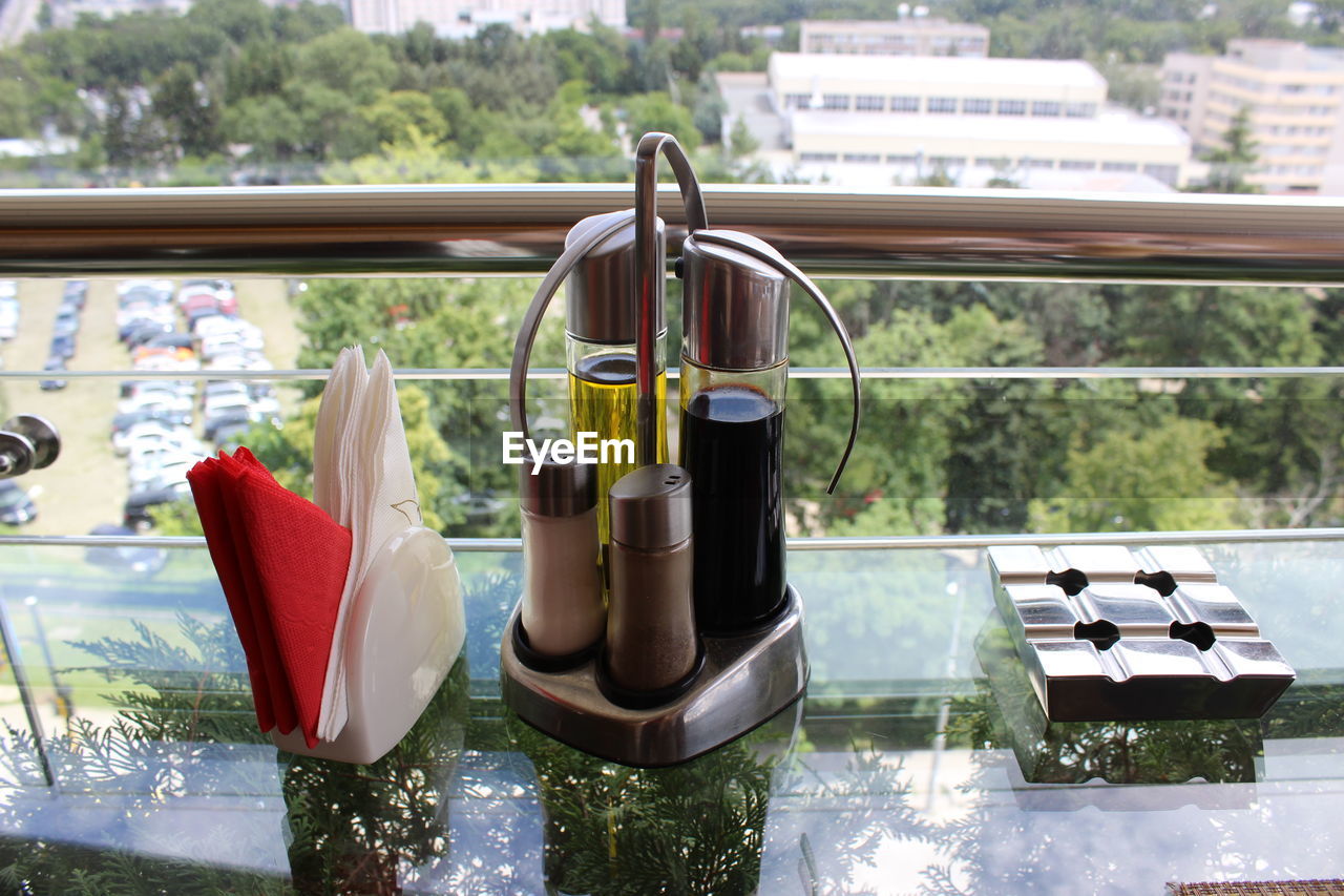 High angle view of ashtray on glass table at restaurant