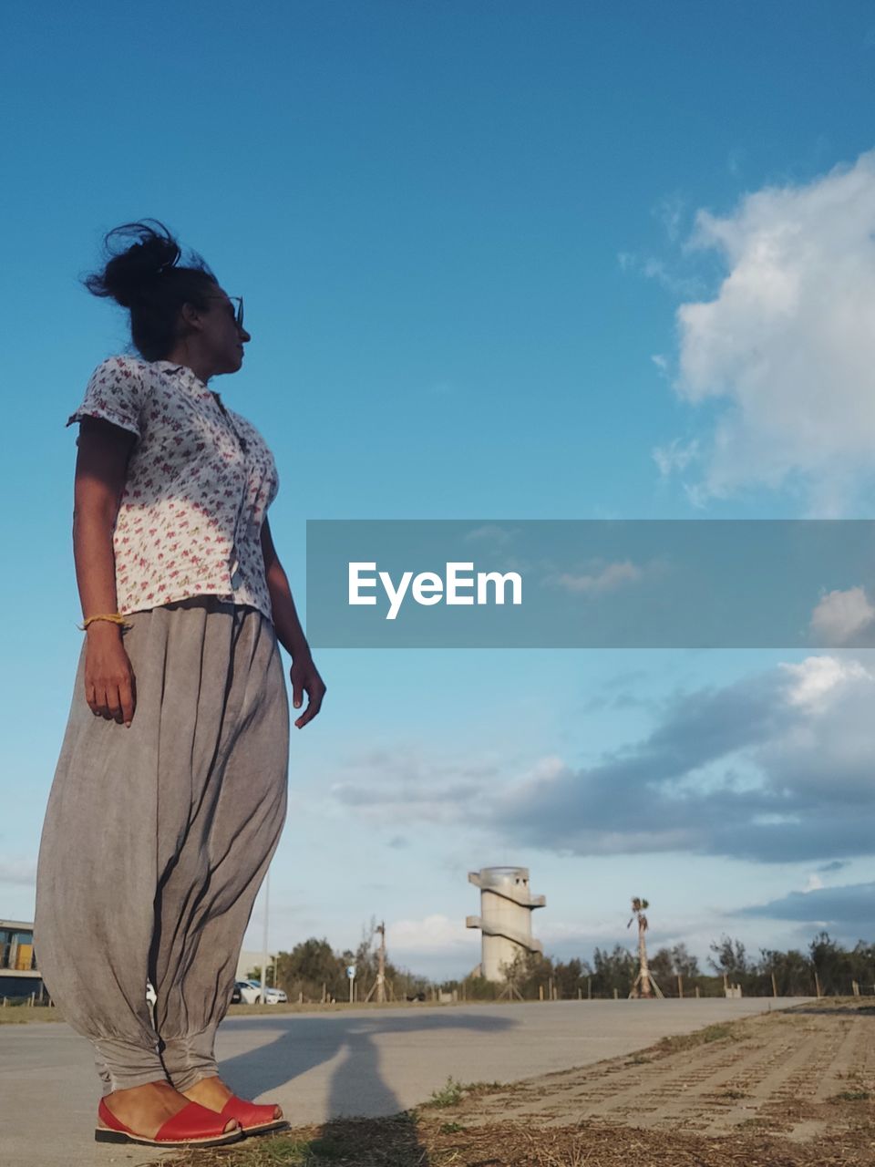 Woman standing on land against sky