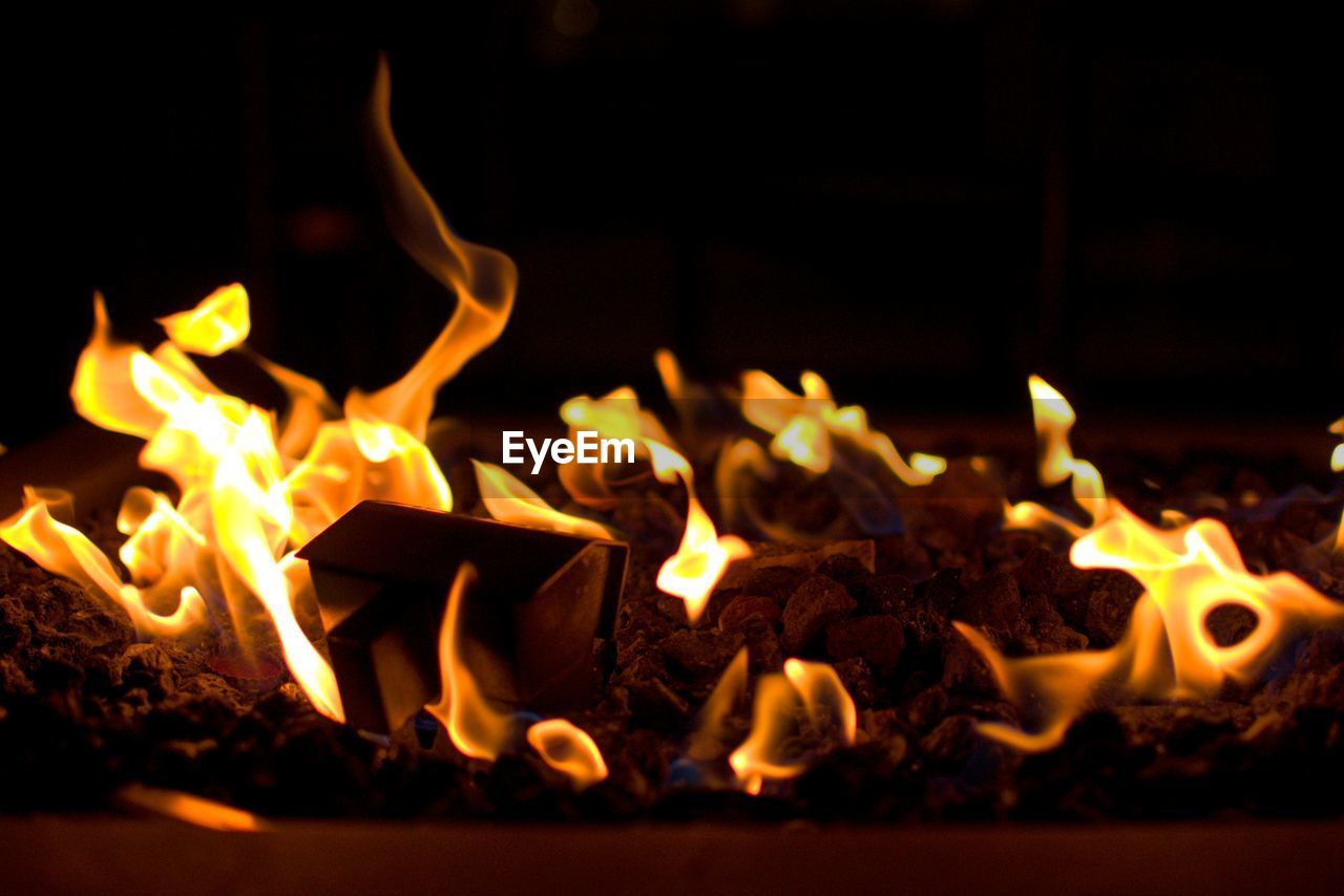 CLOSE-UP OF FIRE BURNING IN DARK