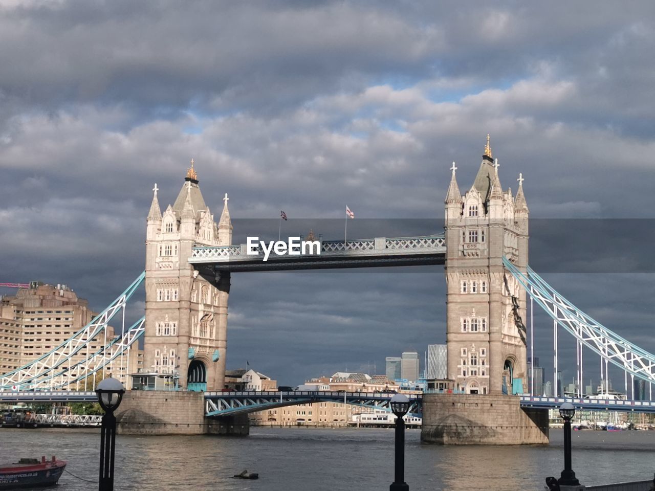 View of bridge over river against cloudy sky