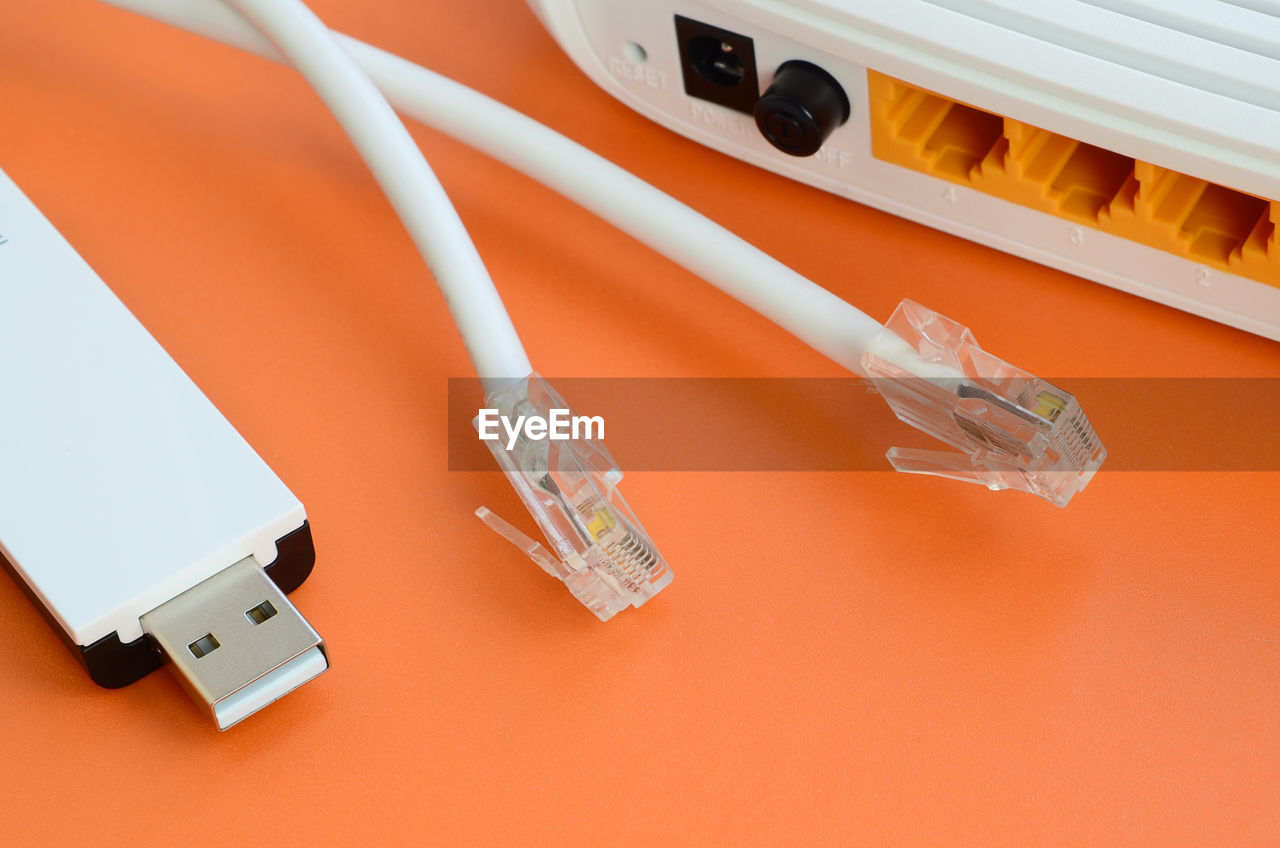 High angle view of computer cables and router on table