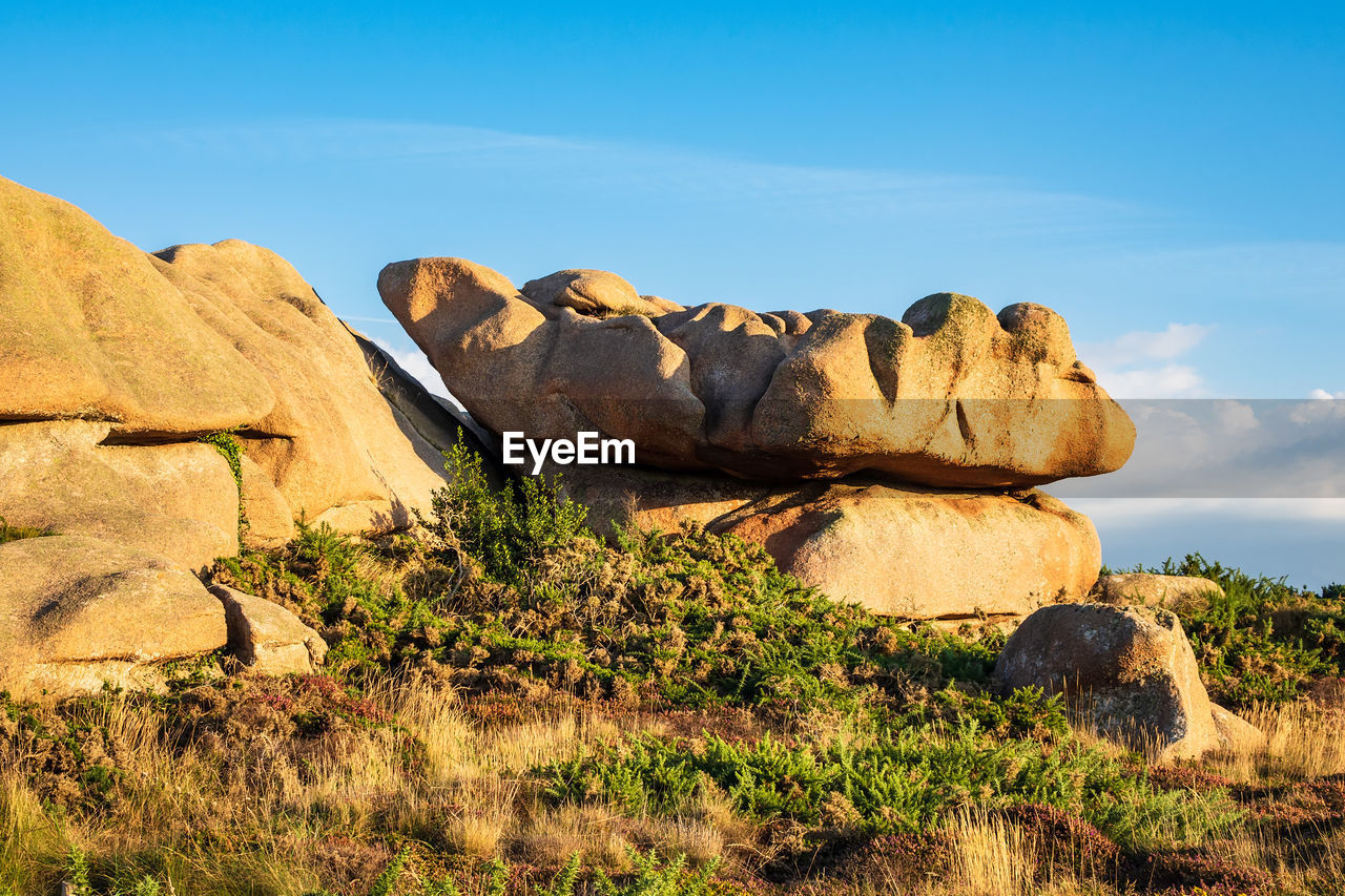 Rock formations on landscape against sky