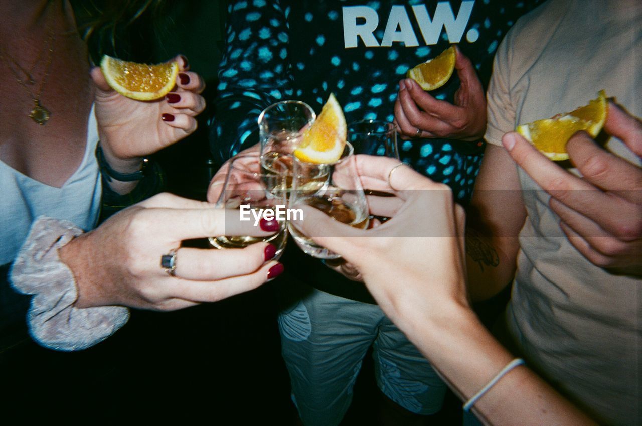 MIDSECTION OF MAN DRINKING WATER FROM GLASS