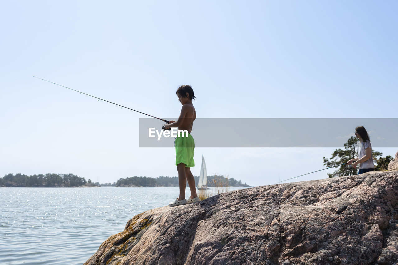 Boy fishing at lake