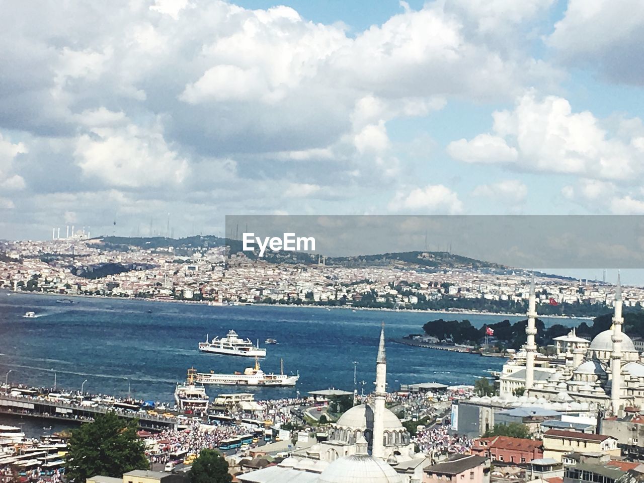 High angle view of town by sea against sky