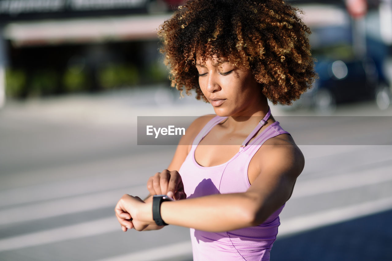 Young woman running on road