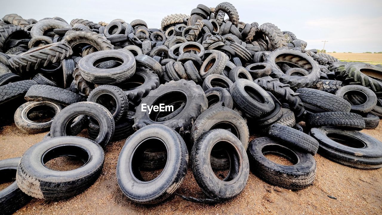 Heap of damaged tires on field