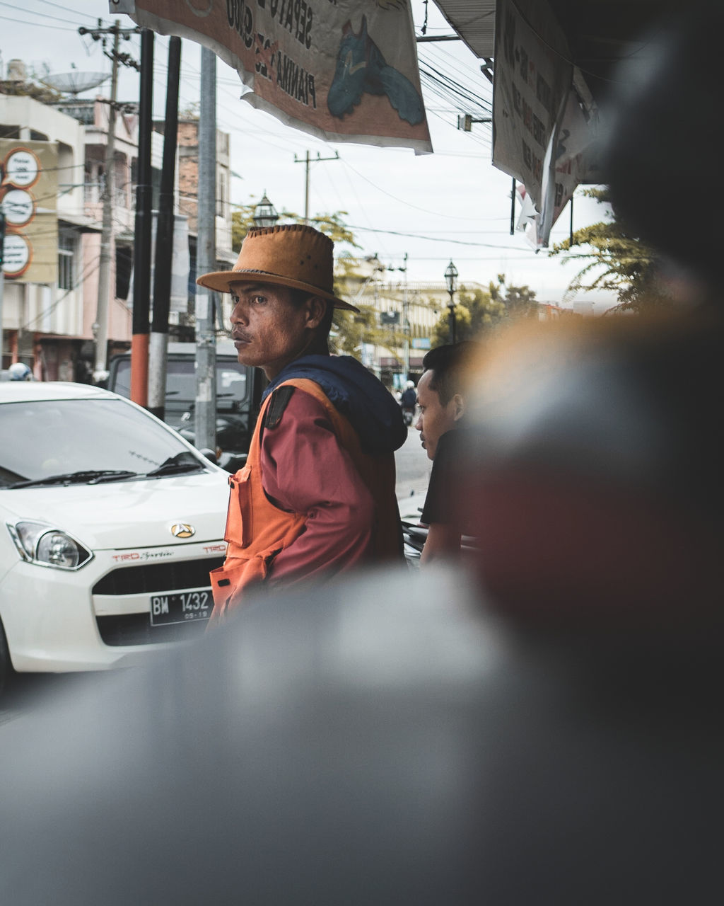 MEN IN CAR ON CITY