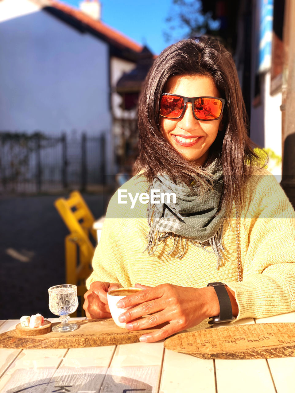 Portrait of young woman sitting on table