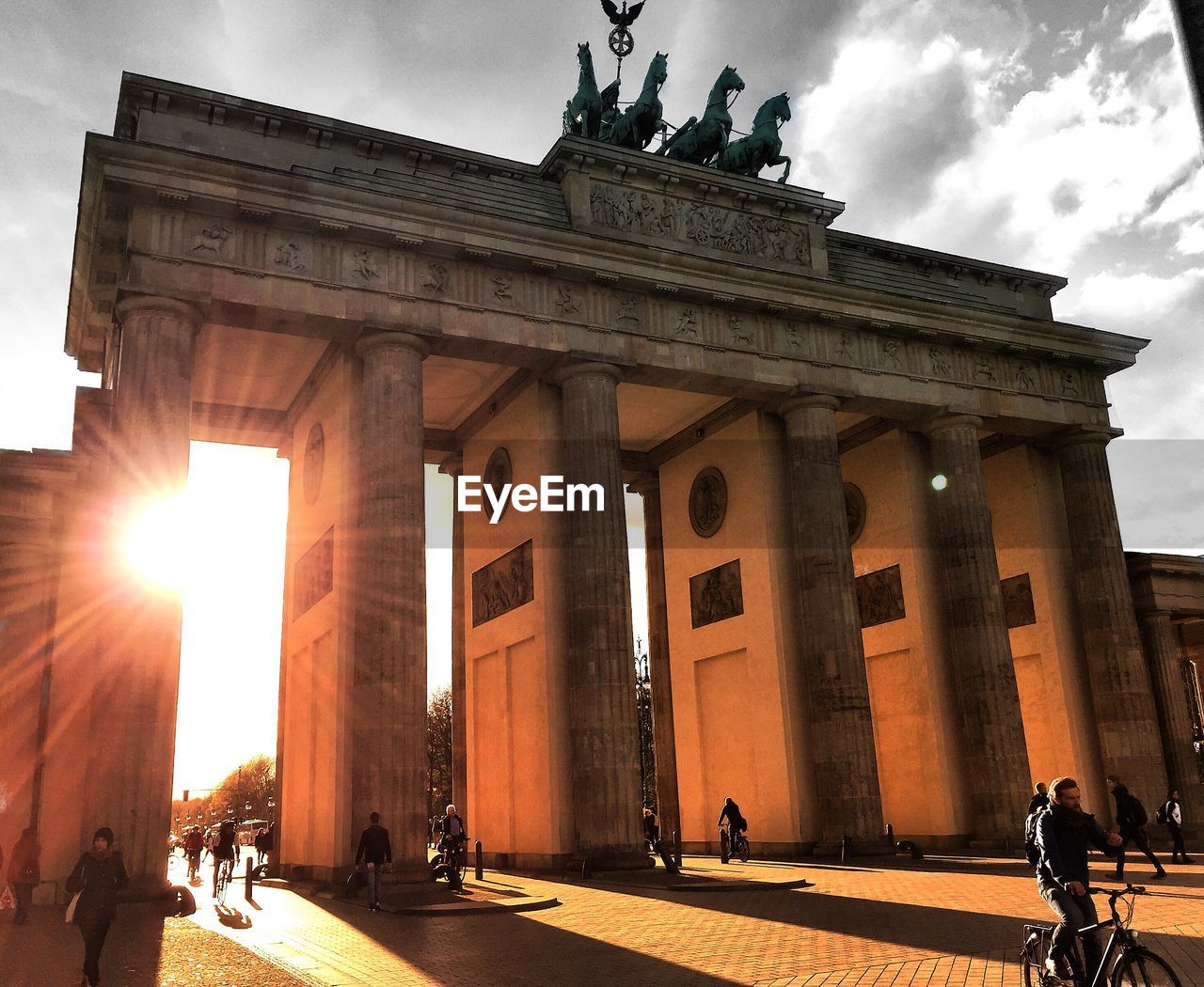 Tourists at brandenburg gate against sky