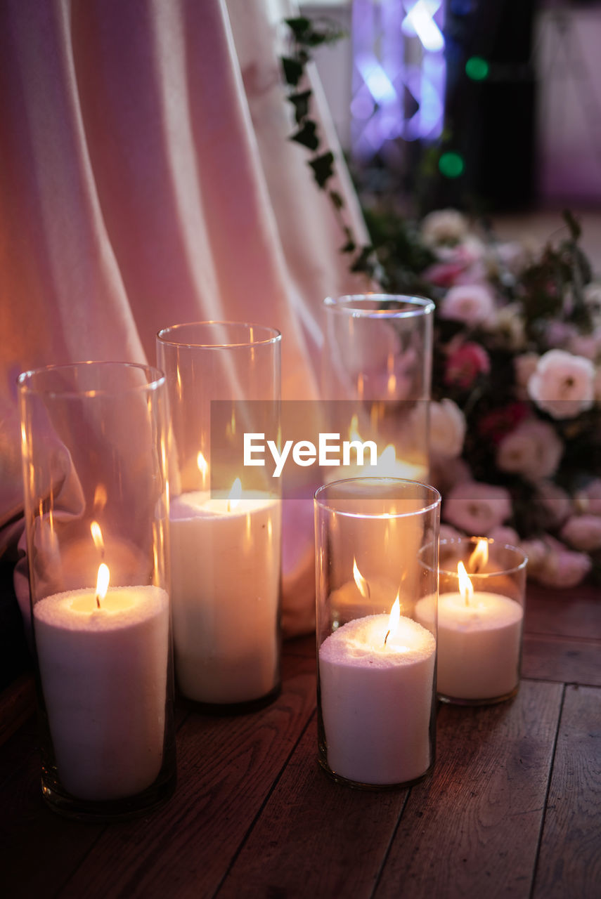 close-up of illuminated candles in temple