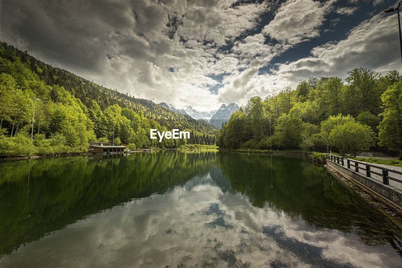 Scenic view of lake by trees against sky