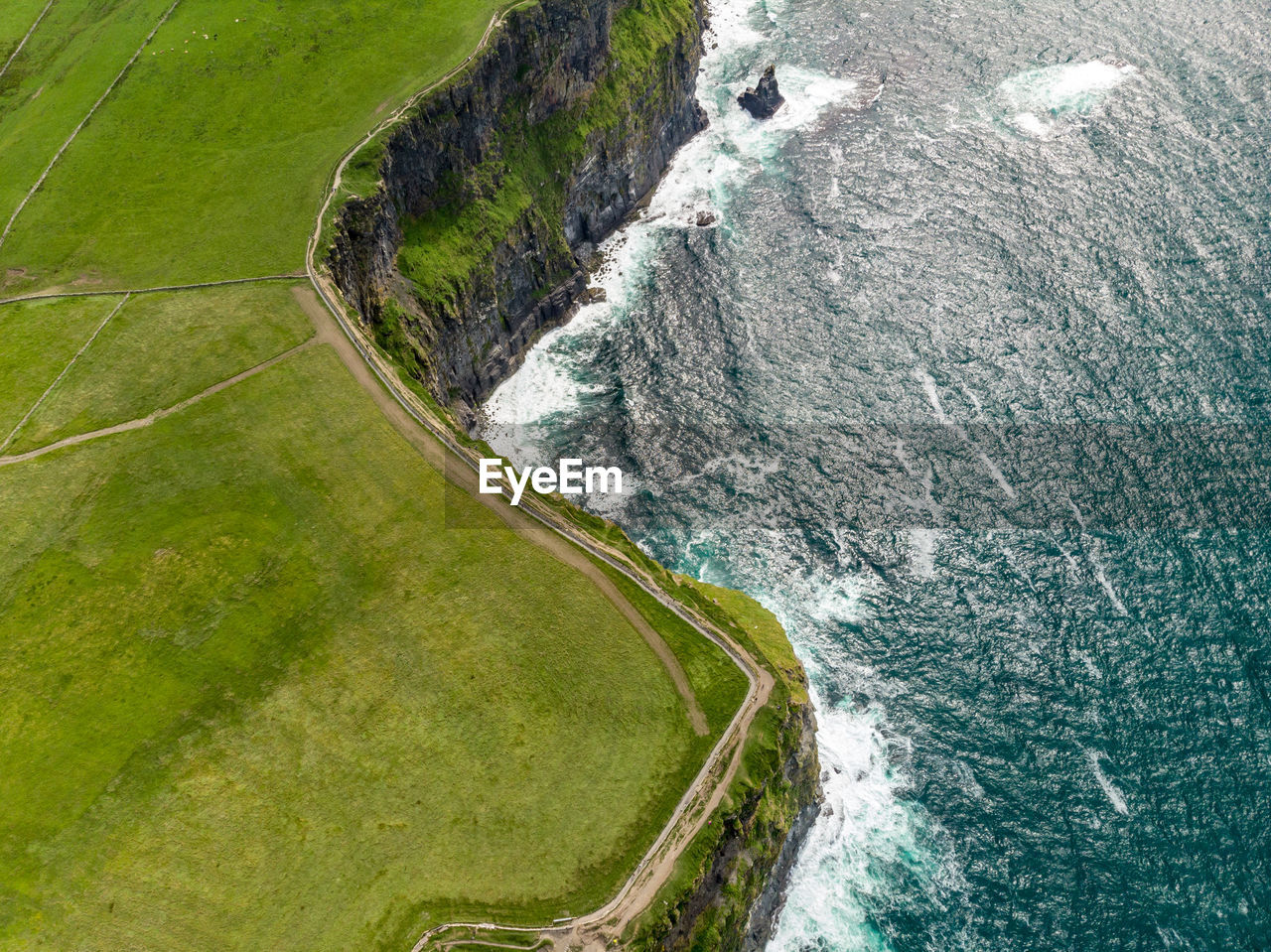 Aerial view of sea by cliff