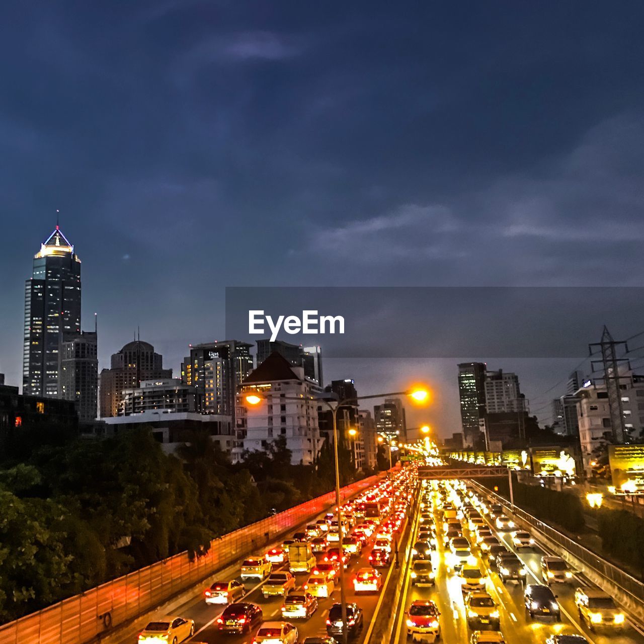 High angle view of illuminated street amidst buildings at night