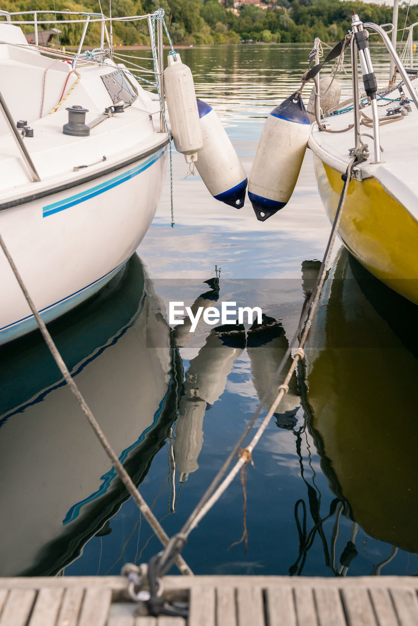 BOATS MOORED ON SEA