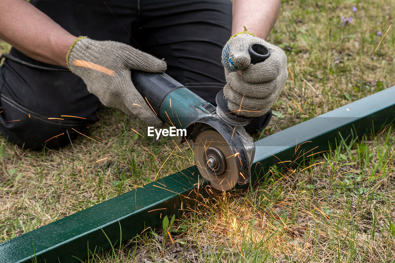 Low section of man working on land