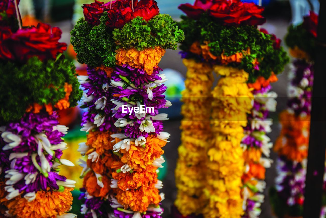 Close-up of floral garlands for sale at market stall
