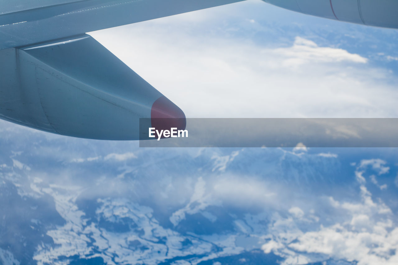 AIRPLANE WING OVER CLOUDS