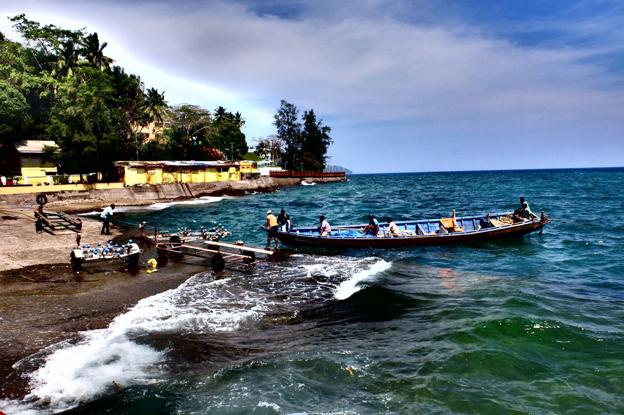 PEOPLE IN SEA AGAINST SKY