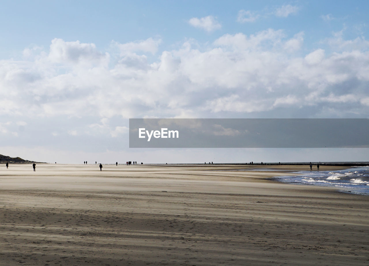 VIEW OF BEACH AGAINST CLOUDY SKY