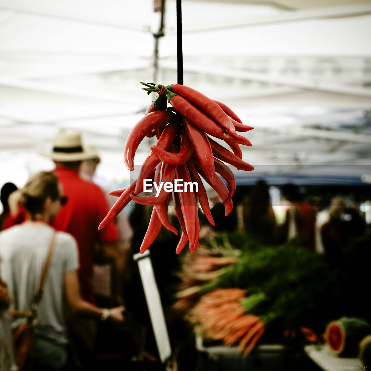 Close-up of red chili pepper hanging on market stall