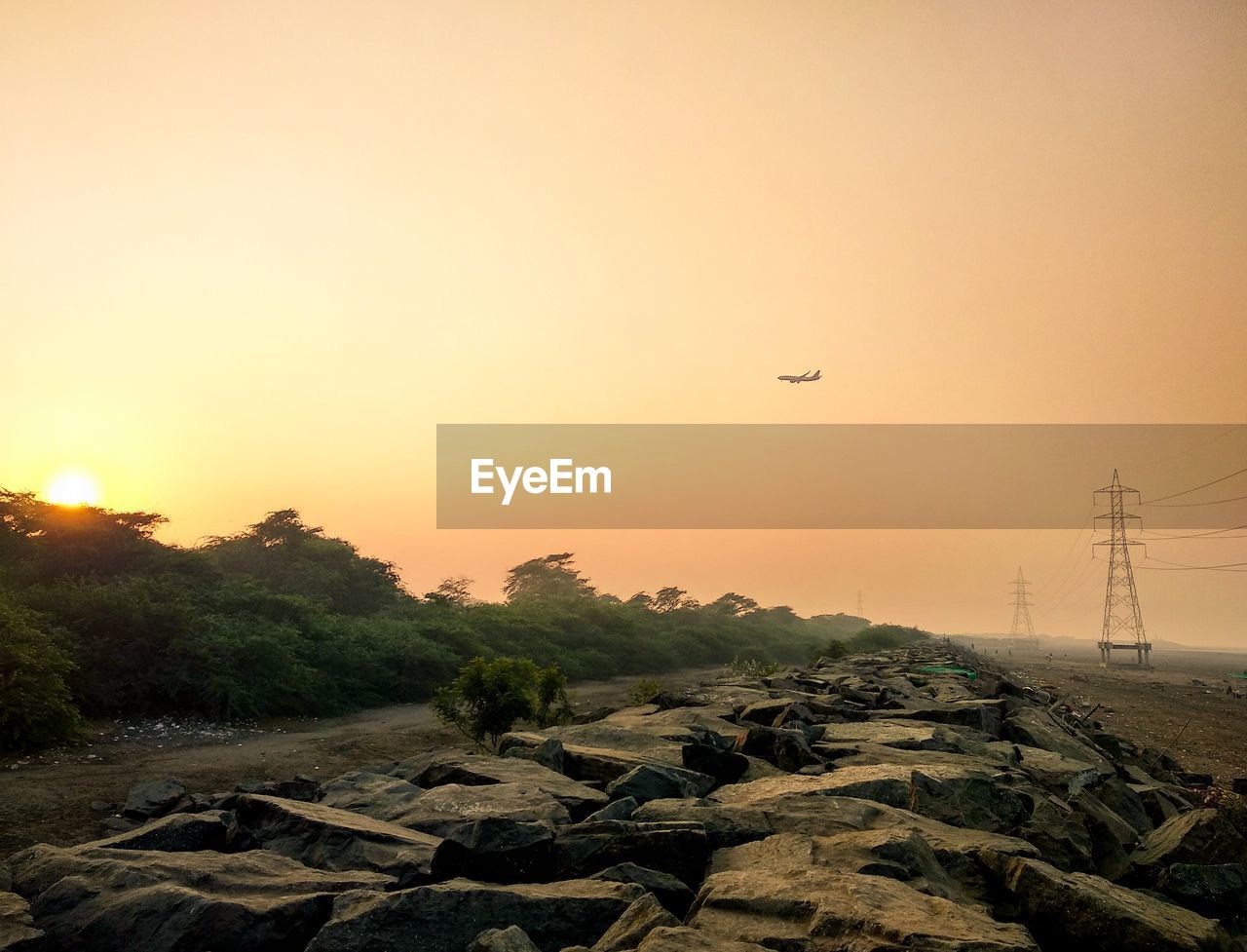 SCENIC VIEW OF LAND AGAINST SKY DURING SUNSET