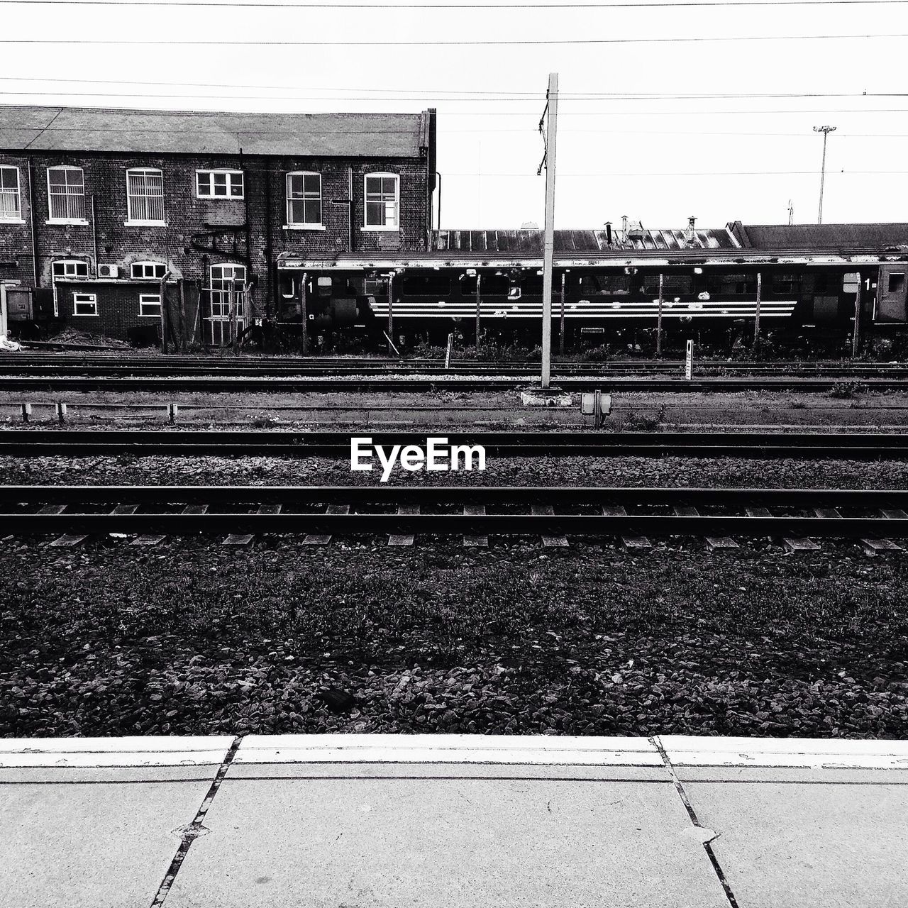 RAILROAD TRACKS BY BUILDINGS IN CITY