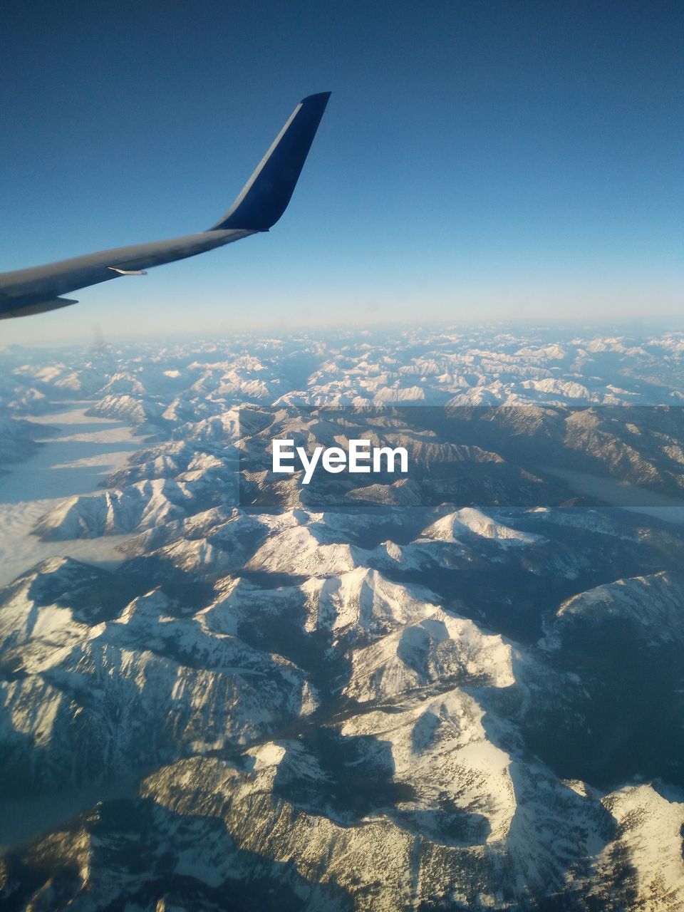 Cropped image of airplane flying over landscape