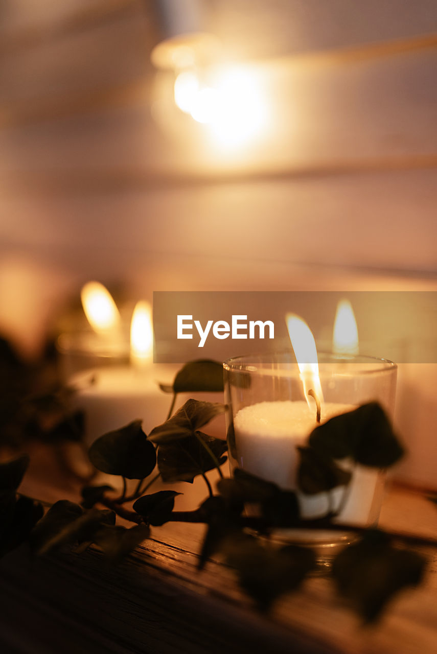 close-up of illuminated candle on table