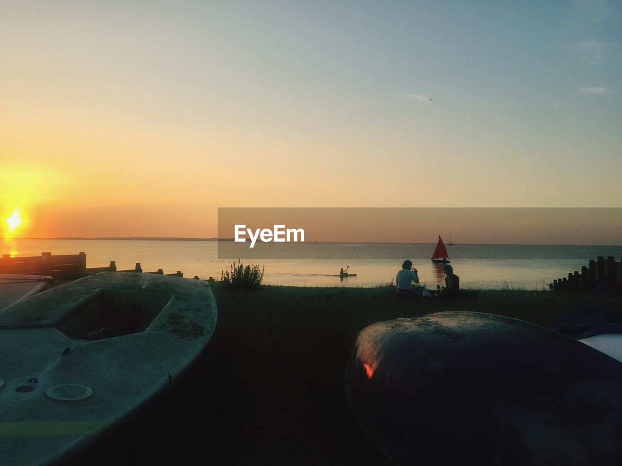 VIEW OF CALM SEA AT SUNSET