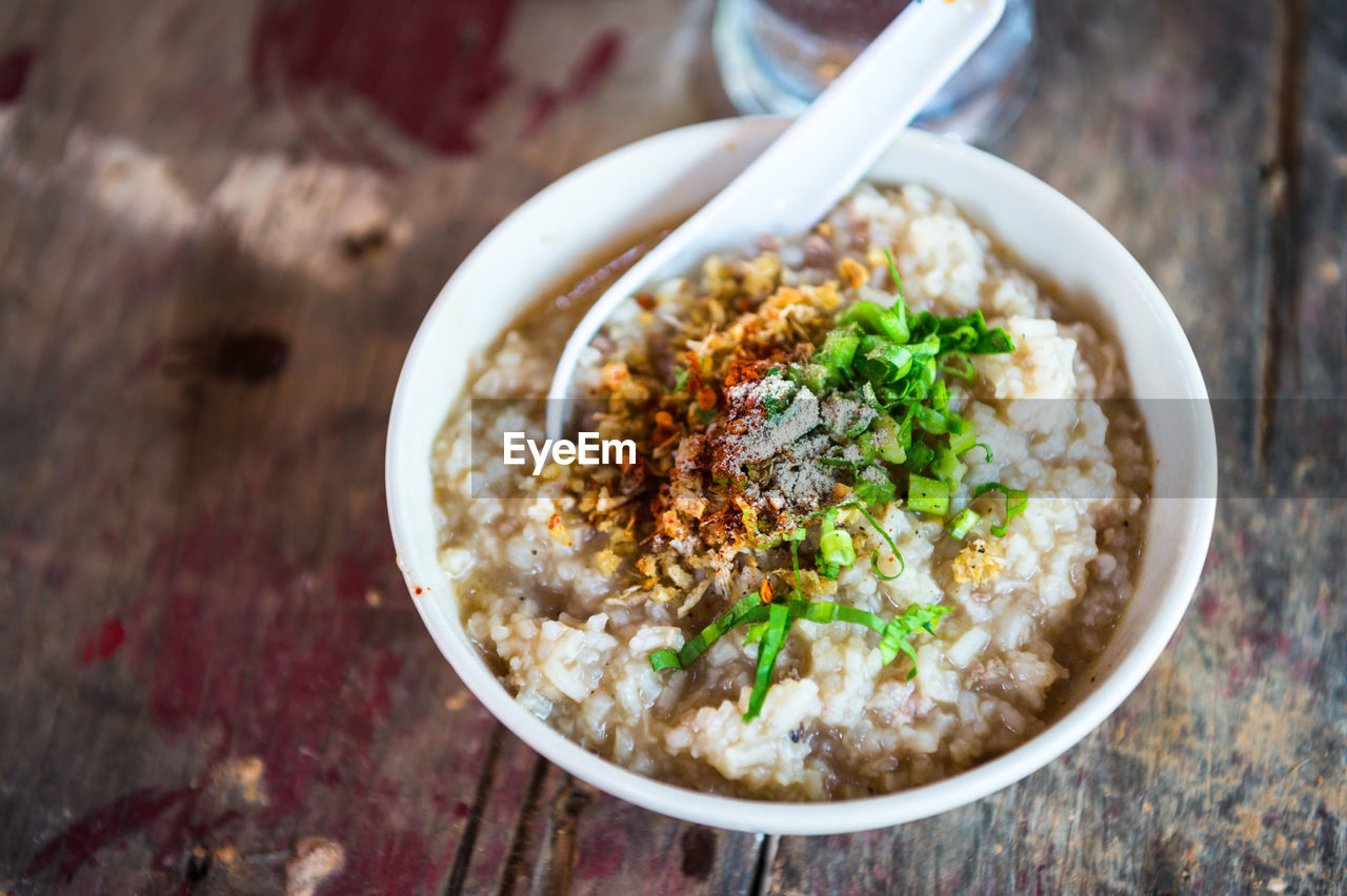 High angle view of congee in bowl on table