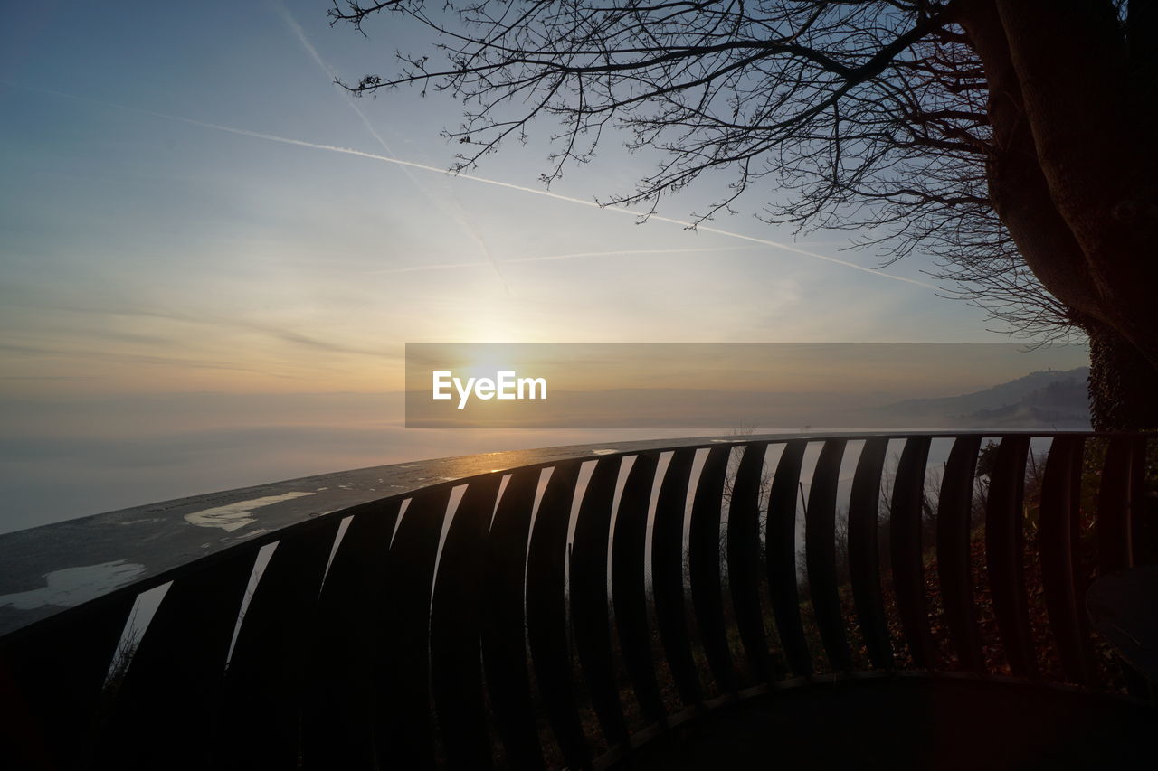 SCENIC VIEW OF SUNSET AGAINST SKY DURING FOGGY WEATHER