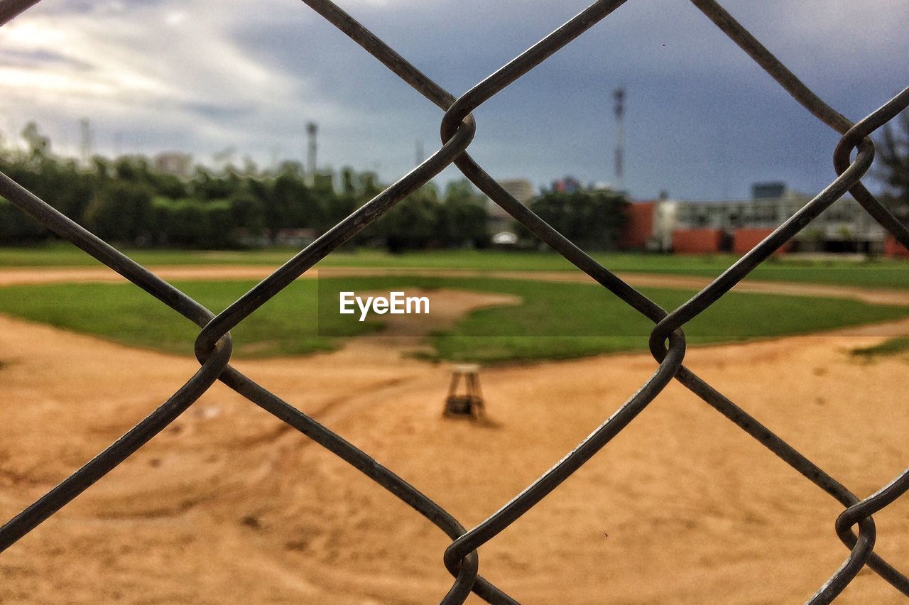 Close-up of chainlink fence against sky