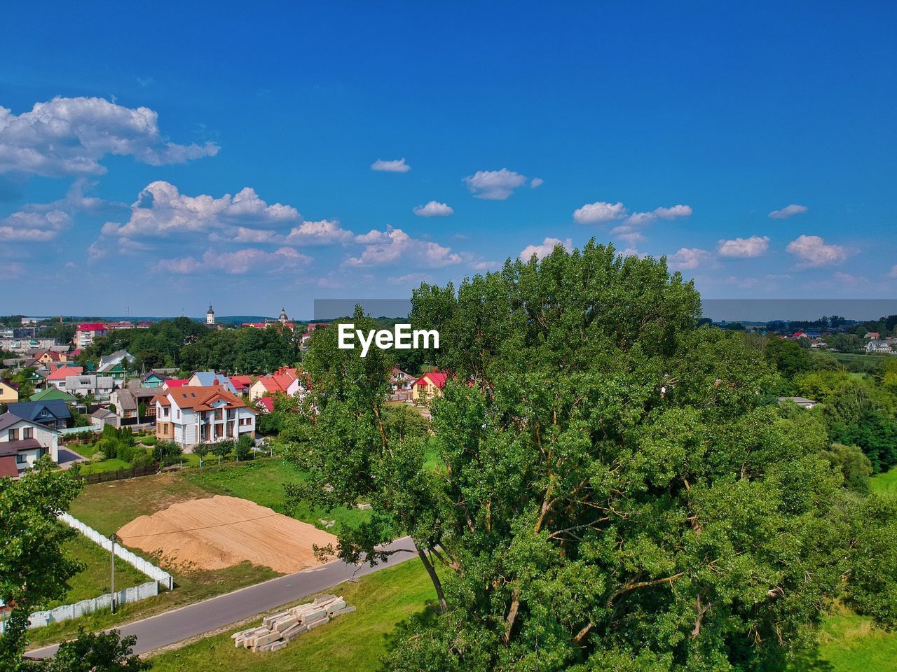 TREES AND HOUSES AGAINST SKY